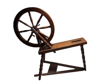 May include: A vintage wooden spinning wheel with a large, dark brown wheel and a rectangular base. The wheel has multiple spokes and is connected to the base by a series of wooden supports. The spinning wheel is designed for textile production.