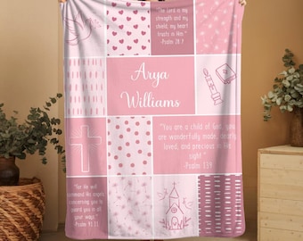 May include: A pink and white patchwork blanket featuring religious symbols, text, and the name "Arya Williams." The blanket includes a dove, hearts, a cross, a church, and inspirational quotes from Psalms.