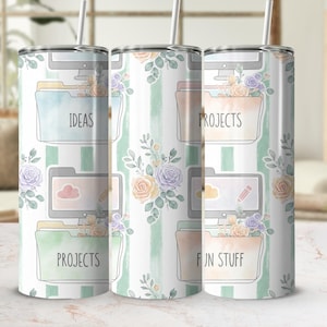 May include: A cylindrical tumbler with a metal straw featuring a repeating pattern of computer monitors, file folders labelled IDEAS, PROJECTS, and FUN STUFF, and watercolour floral arrangements in shades of peach, purple, and green on a striped background.