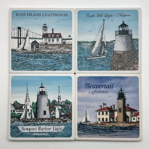 May include: Set of four square coasters featuring illustrations of lighthouses in Newport, Rhode Island. Each coaster has a different lighthouse design with a blue and white color scheme. The coasters are made of ceramic and have a cork backing.