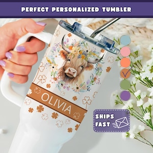 May include: White personalized tumbler featuring a watercolor illustration of a Highland cow with a floral crown. The tumbler includes the name "Olivia" and shamrock accents. A straw and lid are visible. The text "SHIPS FAST" is also present.