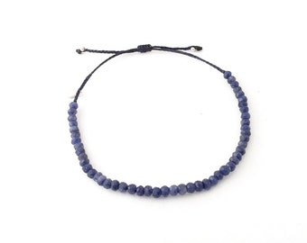 Beaded adjustable sapphire bracelet; made with genuine sapphire gemstone beads; on waxed and braided thread; finished with square knot