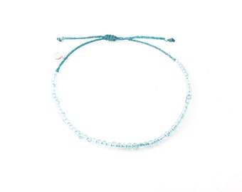 Beaded adjustable aquamarine bracelet; with 3mm genuine aquamarine gemstone beads; on waxed and braided thread; finished with a square knot