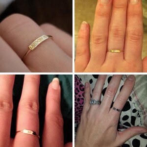 May include: Four different gold rings with engraved lettering. The rings are worn on different fingers. The rings are engraved with the names Landon, Noah, SR, and a ring with a diamond.