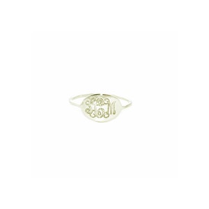 May include: A silver ring with an oval-shaped band featuring a monogrammed design. The monogram is in a script font and includes the letters "LSM".