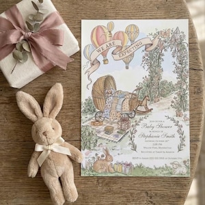 May include: A white ceramic mug with a black handle and the text "But First, Coffee" in a black, handwritten-style font. The mug is on a white surface.