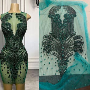 May include: Green beaded fabric with a design of a stylised fountain. The fabric is sheer and has a mesh texture.