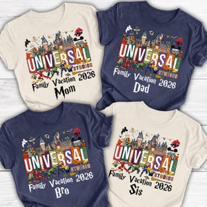 May include: Four short-sleeved t-shirts with a Universal Studios theme. Each shirt has a different color: cream, navy blue, and light cream. The shirts have the text "UNIVERSAL STUDIOS Family Vacation 2026" with "Mom", "Dad", "Bro", and "Sis" printed below.