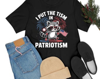 Camiseta deportiva divertida con el lema "I Put The Tism in Patriotism" para hombres y mujeres.