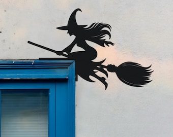 May include: A black silhouette of a witch on a broomstick, with a pointed hat and long hair. The witch is depicted in flight, with the broom angled upwards. This decorative item is likely for Halloween or a similar seasonal event.