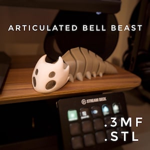May include: A 3D-printed articulated Bell Beast figurine in off-white and tan. The text "ARTICULATED BELL BEAST" is above the figurine. The text ".3MF" and ".STL" are below a Stream Deck.