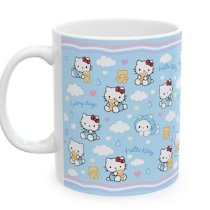 May include: White ceramic mug featuring a repeating pattern of Hello Kitty characters, teddy bears, clouds, and raindrops on a light blue background. The mug has the text "funny days" and "Hello Kitty".