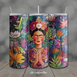 May include: A cylindrical tumbler featuring a vibrant, colorful illustration of a person with dark hair adorned with a large floral crown, hands pressed together in a prayer gesture, surrounded by a dense, lush pattern of tropical flowers and leaves.