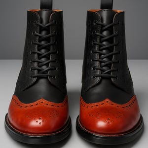May include: A pair of two-tone leather boots. The upper portion is black, while the toe and lower section are a reddish-brown. The boots have a lace-up design with black laces and a decorative pattern on the toe.