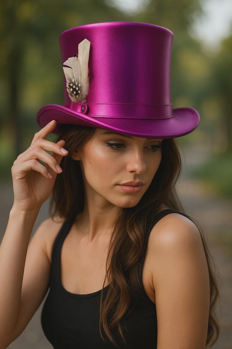May include: A vibrant magenta top hat with a feather accent. The hat features a classic tall crown and a wide brim. The feather is white with dark spots. The hat is a striking accessory.