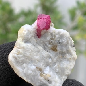 May include: A set of three ceramic mugs with a speckled, cream-colored glaze. Each mug features a different hand-painted floral design in shades of blue, green, and yellow. The mugs have a simple, rounded shape and a comfortable handle.