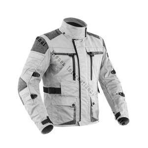 May include: A light gray motorcycle jacket featuring dark gray textured shoulder and elbow panels, a high collar, a central zipper, multiple front pockets with black zippers, and adjustable black side straps for a secure fit.