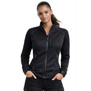 May include: Black zip-up jacket with a stand-up collar. The jacket has a textured design on the sleeves and shoulders, with multiple zipped pockets. The model is wearing black trousers. The jacket is a sporty, casual style.