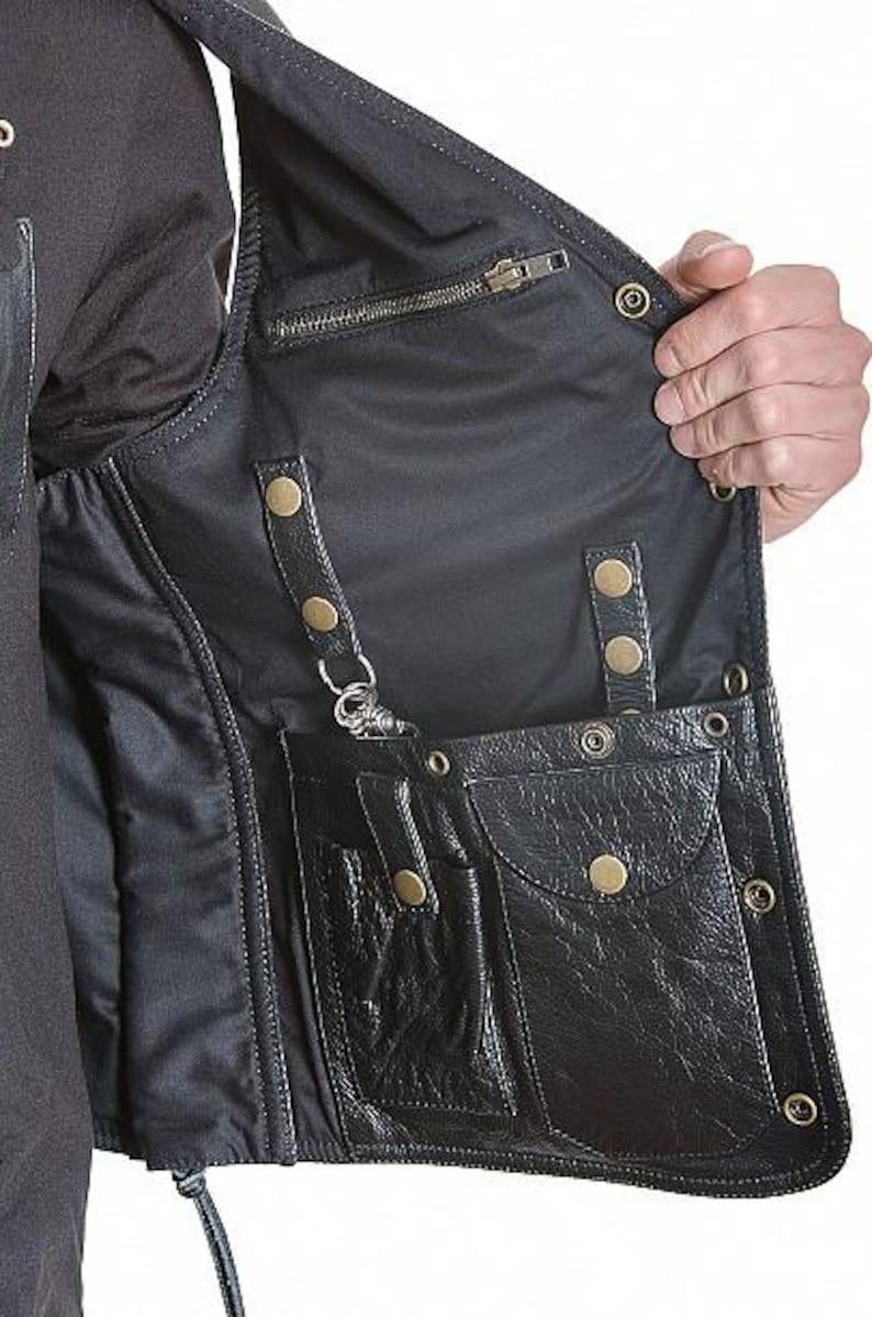 May include: Black leather vest with multiple pockets, snap closures, and a zipper. The vest has a satin lining and a key clip. The vest is designed with a classic biker style.