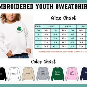 May include: White embroidered youth sweatshirt with a green shamrock and the text "Lucky Little Dude". The image includes a size chart with measurements in inches and centimeters, and a color chart with options like black, white, and navy.