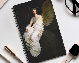 May include: Spiral-bound notebook featuring a classical painting of an angel with large wings, seated on a rock. The artwork is predominantly dark with the angel in a white gown. The notebook has a black cover and a silver spiral binding.
