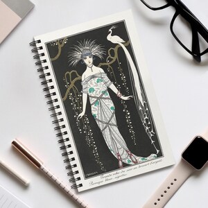 May include: Spiral-bound notebook with an art deco illustration of a woman in a gown, a peacock, and French text. The artwork is set against a black background with gold accents. The notebook has a white border and is ideal for notes.