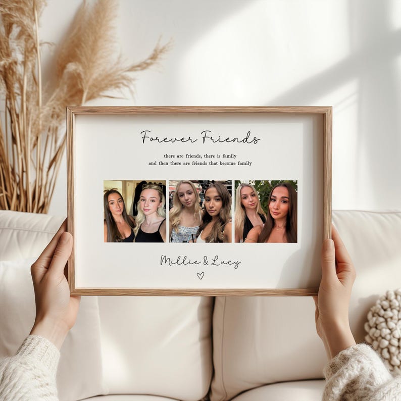 May include: A framed print with the text "Forever Friends" and a series of six photographs. The print includes the names "Millie & Lucy" and a heart symbol. The frame is a light brown color.