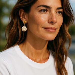 Gold stud and pearl earrings.