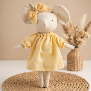 May include: A set of three ceramic mugs with a speckled, matte finish. The mugs are in shades of cream, light gray, and dark gray. Each mug has a simple, minimalist design, perfect for coffee or tea.