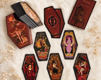 Könnte beinhalten: Ein sargförmiges Tarot-Kartendeck mit dem Titel Aisling, bestehend aus einer Schachtel, einer Anleitung und mehreren Karten mit illustrierten Figuren in Rot-, Schwarz- und Goldtönen. Die Karten zeigen verschiedene Symbole und Figuren.