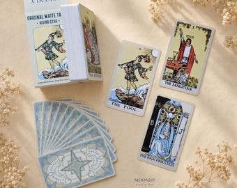 May include: A deck of Original Waite Tarot Rising Star cards featuring a white box with the text JOVENLY and ORIGINAL WAITE TAROT RISING STAR. The set includes individual cards titled The Fool, The Magician, and The High Priestess with illustrations.