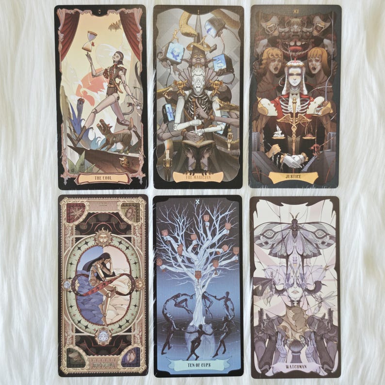 May include: Six rectangular tarot cards featuring intricate illustrations. The cards depict The Fool, The Magician, Justice, The World, Ten of Cups, and Watchman, each with detailed figures, symbolic imagery, and ornate borders in muted tones.