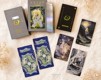 May include: A tarot card deck titled Exile Awaken, featuring a gray box with gold foil accents, a black instruction booklet, and several cards displaying detailed illustrations including The Fool, The Lovers, and The Magician with blue floral backs.