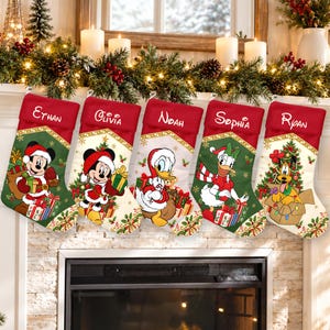 May include: Five personalised Christmas stockings featuring Disney characters. Each red-cuffed stocking displays a name: Ethan, Olivia, Noah, Sophia, or Ryan. The designs include Mickey, Minnie, Donald, Daisy, and Pluto with holiday gifts.