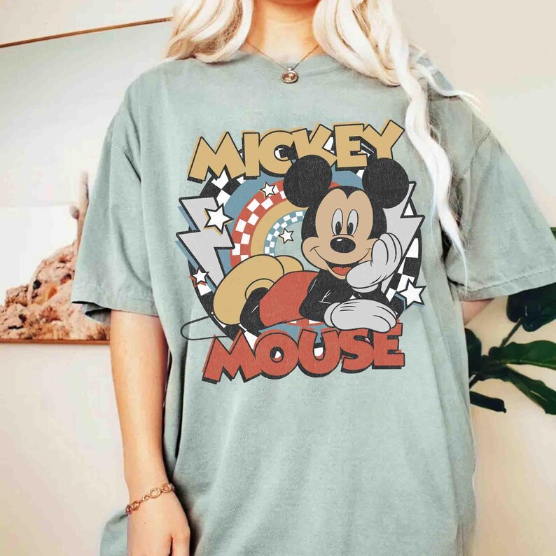 May include: A set of three ceramic mugs with a speckled, matte finish. The mugs are in shades of cream, light gray, and dark gray. Each mug has a simple, minimalist design and a rounded handle. The mugs are likely for coffee or tea.