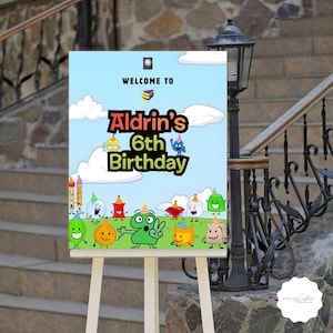 Peut inclure: Panneau d'anniversaire coloré sur chevalet. Il affiche "Bienvenue à Aldrin's 6th Birthday" avec des personnages de dessins animés sur fond de ciel bleu. Le panneau est exposé à l'extérieur, près d'un mur en pierre et d'un escalier.