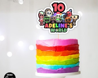 May include: A round cake with horizontal rainbow-coloured frosting layers topped with a custom cake topper featuring the number 10, various cartoon characters, and the text Adeline's World in colourful letters on a white background.
