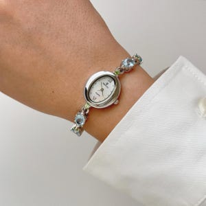 Reloj Vexcel plateado con piedras preciosas azules y verdes, reloj de pulsera para mujer, reloj de joyería.