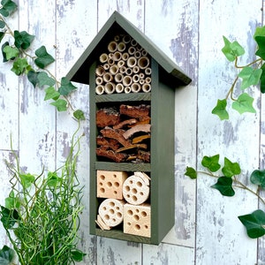 Beautifully handmade three tier wildlife habitat, Bee Hotel, Insect House. Timber and painted in Old English, dark green.
Keyhole hanger provided.
Bamboo, bark and drilled holes provide a perfect home for solitary bees.