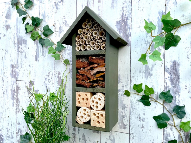 Beautifully handmade three tier wildlife habitat, Bee Hotel, Insect House. Timber and painted in Old English, dark green.
Keyhole hanger provided.
Bamboo, bark and drilled holes provide a perfect home for solitary bees.