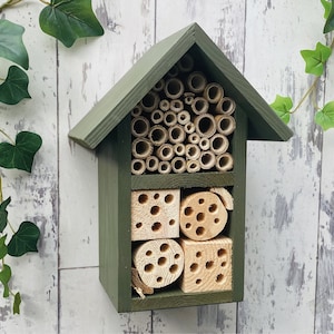 Beautifully handmade two tier wildlife habitat, Bee Hotel, Insect House. Timber and painted in Old English, dark green.
Keyhole hanger provided.
Bamboo, and drilled holes provide a perfect home for solitary bees.