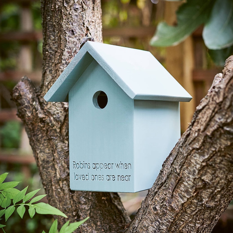 a personalised bird box with 'robins appear when loved appear' engraved on it.