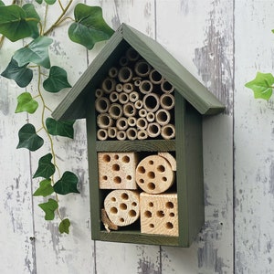 Beautifully handmade two tier wildlife habitat, Bee Hotel, Insect House. Timber and painted in Old English, dark green.
Keyhole hanger provided.
Bamboo, and drilled holes provide a perfect home for solitary bees.