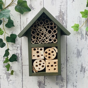 Beautifully handmade two tier wildlife habitat, Bee Hotel, Insect House. Timber and painted in Old English, dark green.
Keyhole hanger provided.
Bamboo, and drilled holes provide a perfect home for solitary bees.