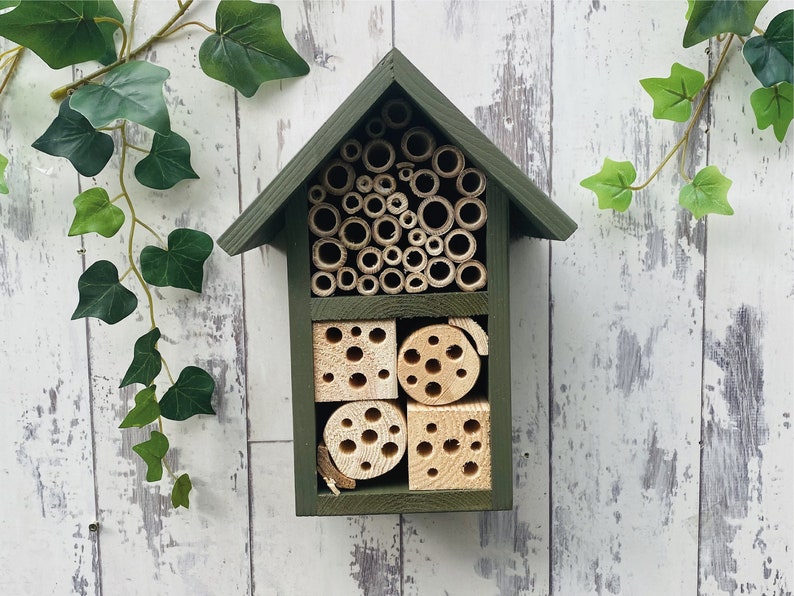 Beautifully handmade two tier wildlife habitat, Bee Hotel, Insect House. Timber and painted in Old English, dark green.
Keyhole hanger provided.
Bamboo, and drilled holes provide a perfect home for solitary bees.