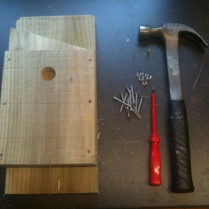 Put together in 10-15 minutes. Kit includes: 6 pieces of timber, roofing felt, screw, nails and an instruction sheet.