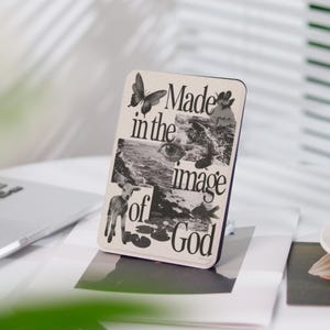 May include: A beige card with a collage of images and the text "Made in the image of God". The images include a butterfly, an eye, a wave, and a lamb.