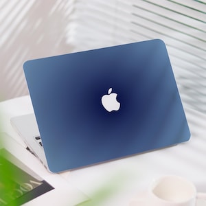 May include: A blue laptop computer with a white Apple logo on the lid.