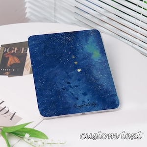 May include: A tablet case with a blue galaxy design, featuring stars and the text "Angelababy". The case has a clear border and the words "custom text" are at the bottom.