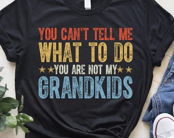 May include: Black t-shirt with a vintage-style graphic that reads "You can't tell me what to do. You are not my grandkids."